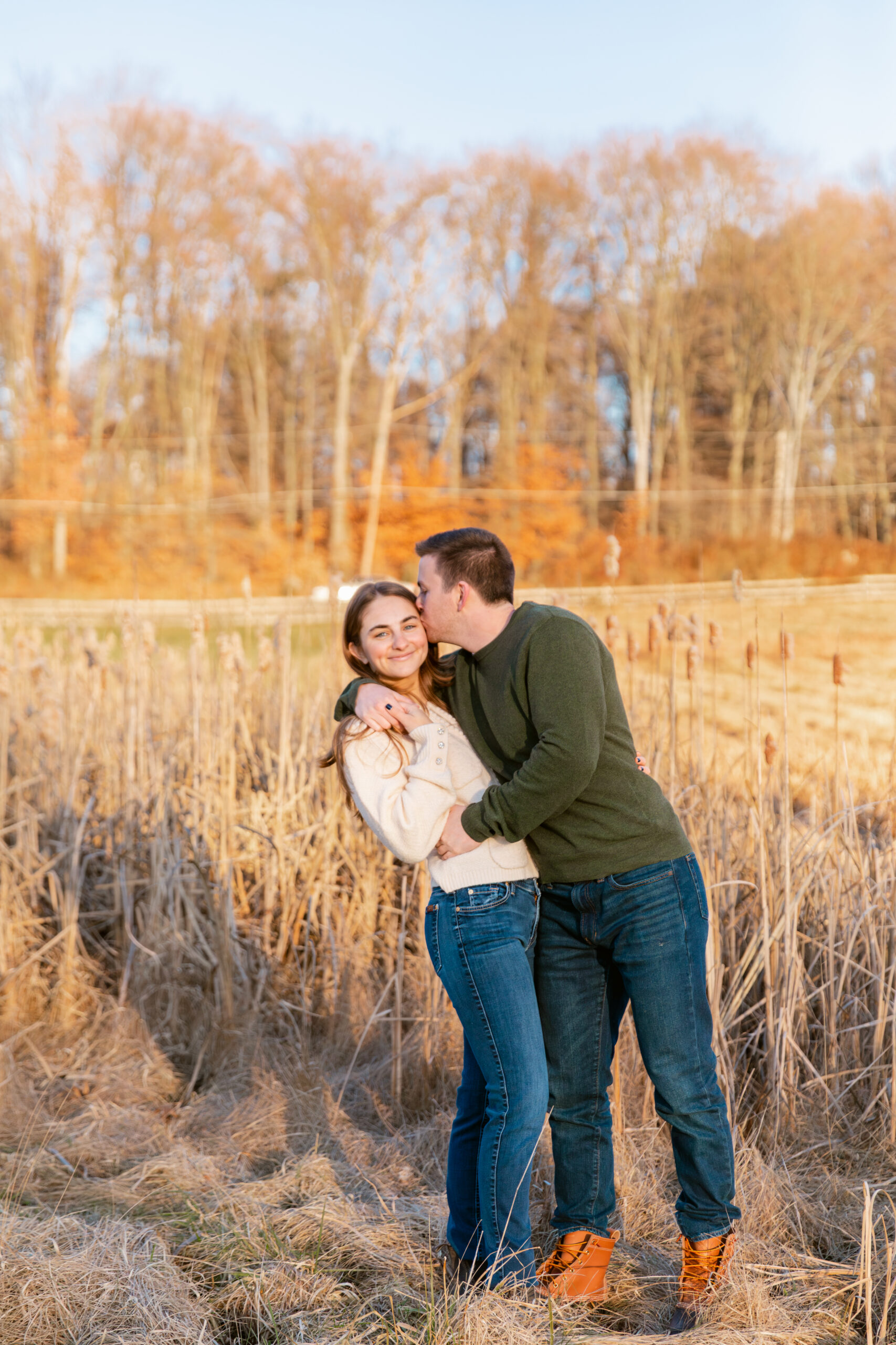 Couple posing in a field of phragmites 