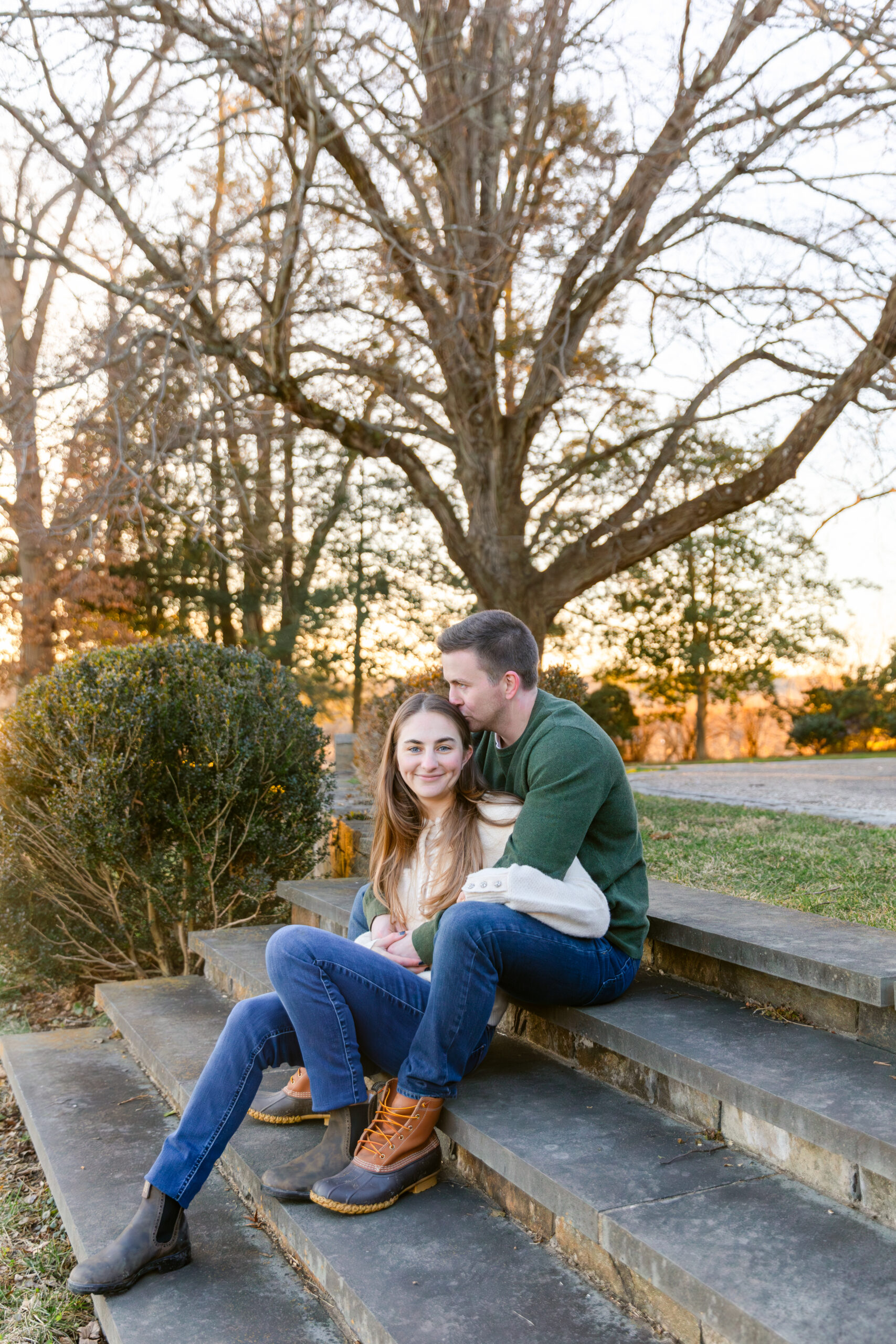 Couple sitting on stairs with sunset