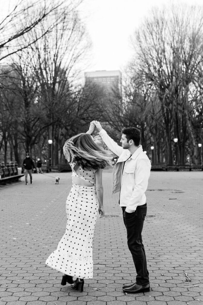 Couple twirling at the central park mall