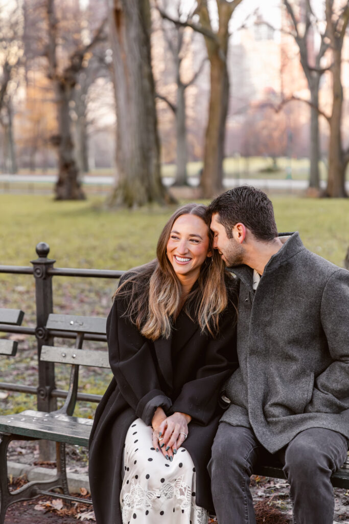 Couple smiling on a bench in central park