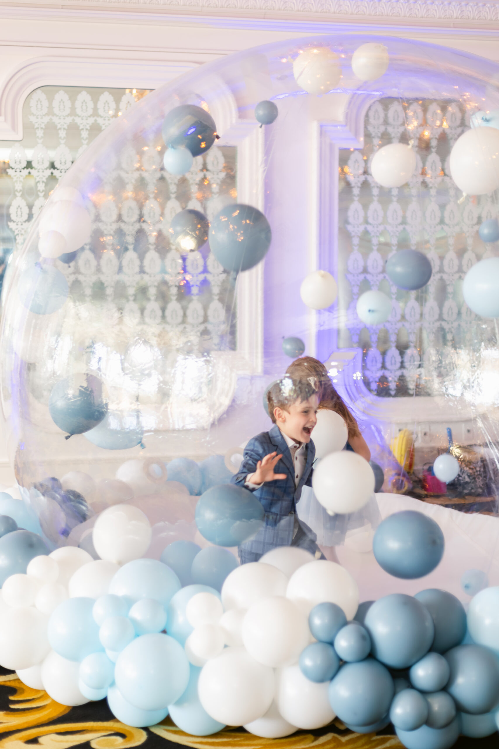 Kids playing in a ballon house at baptism reception