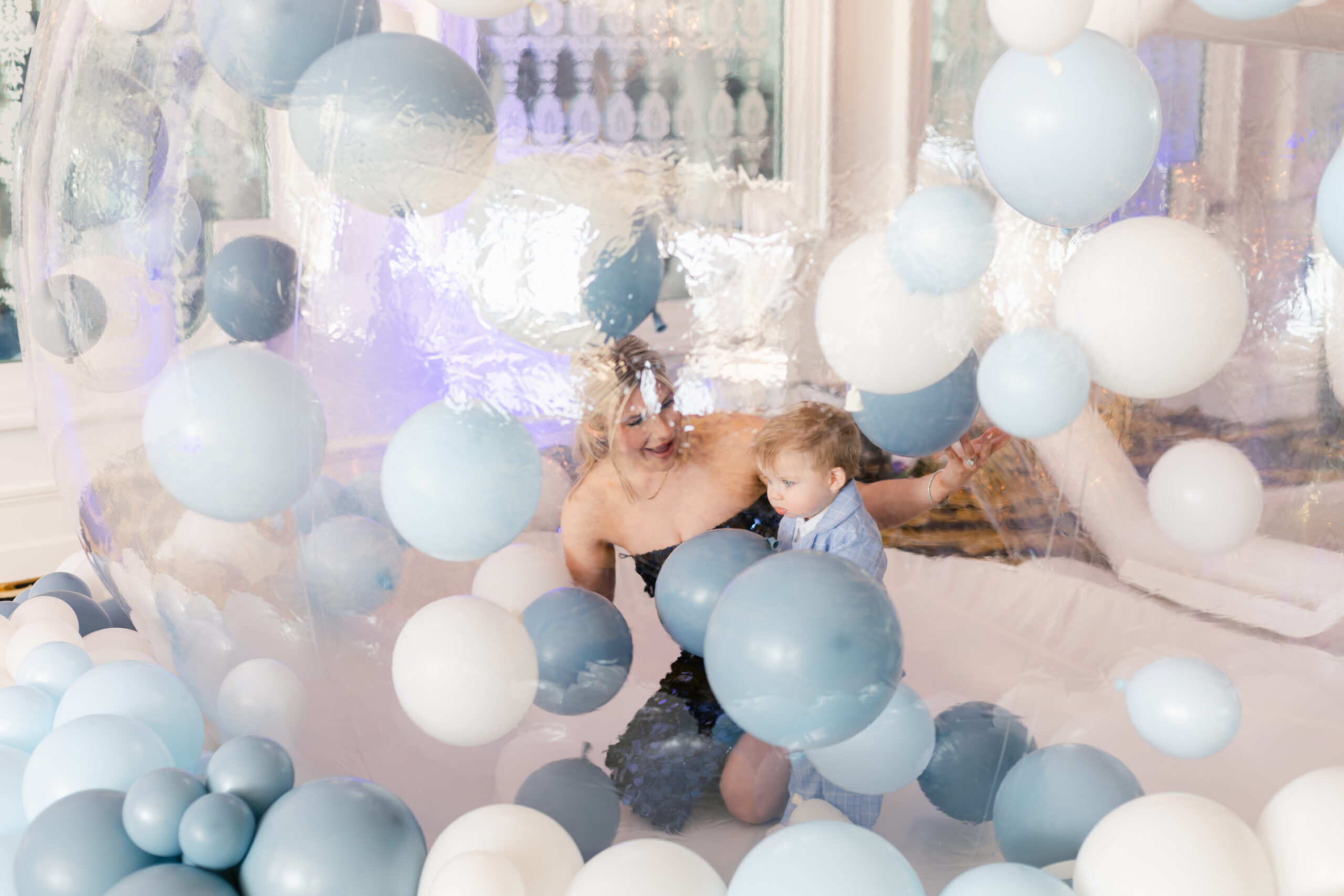 Kids playing in a ballon house at baptism reception