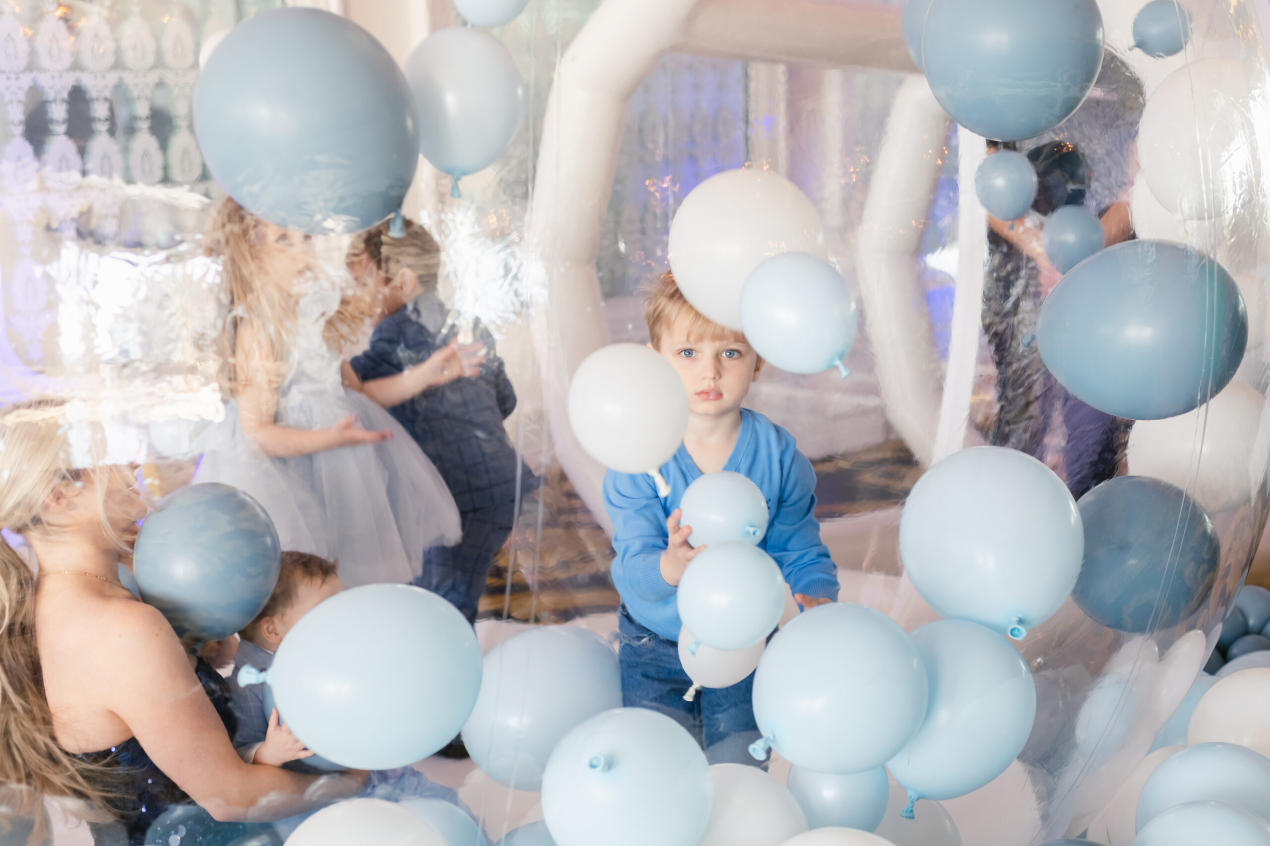 Kids playing in a ballon house at baptism reception