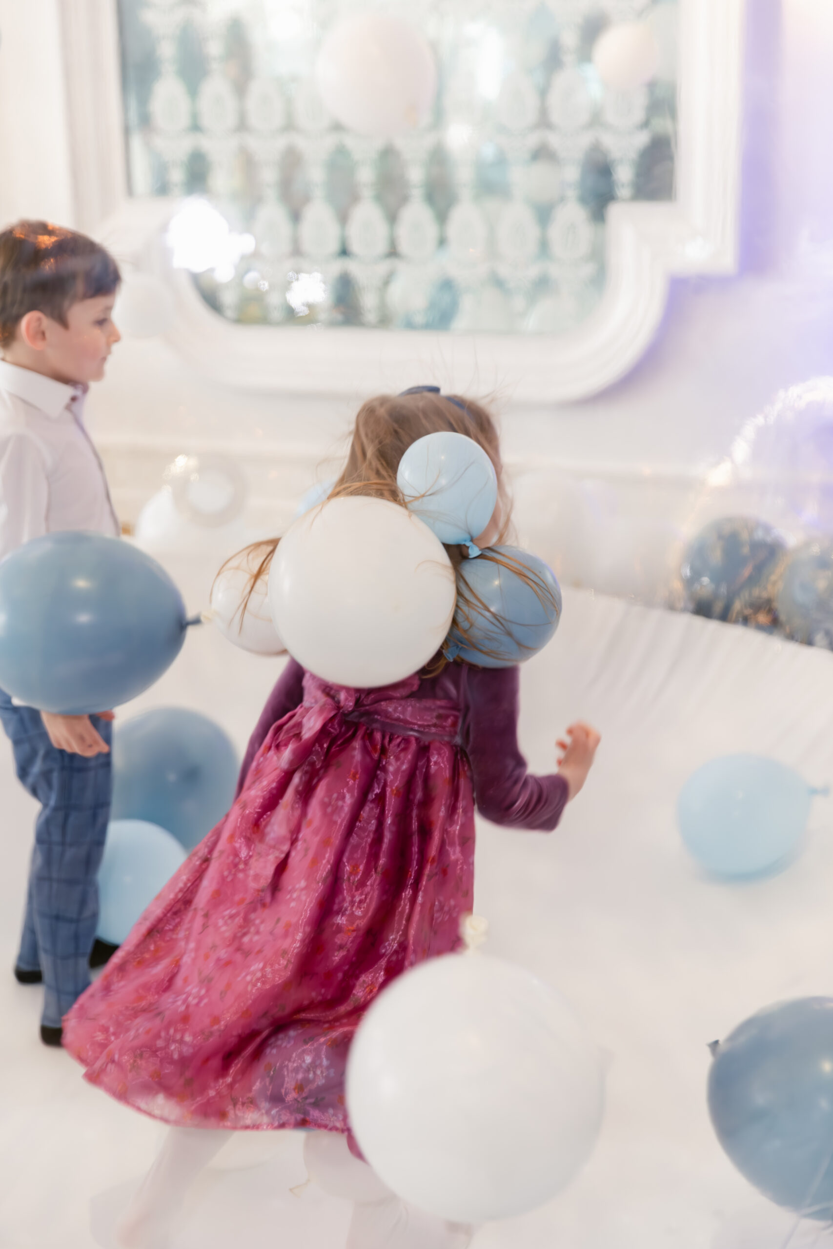 Kids playing in a ballon house at baptism reception