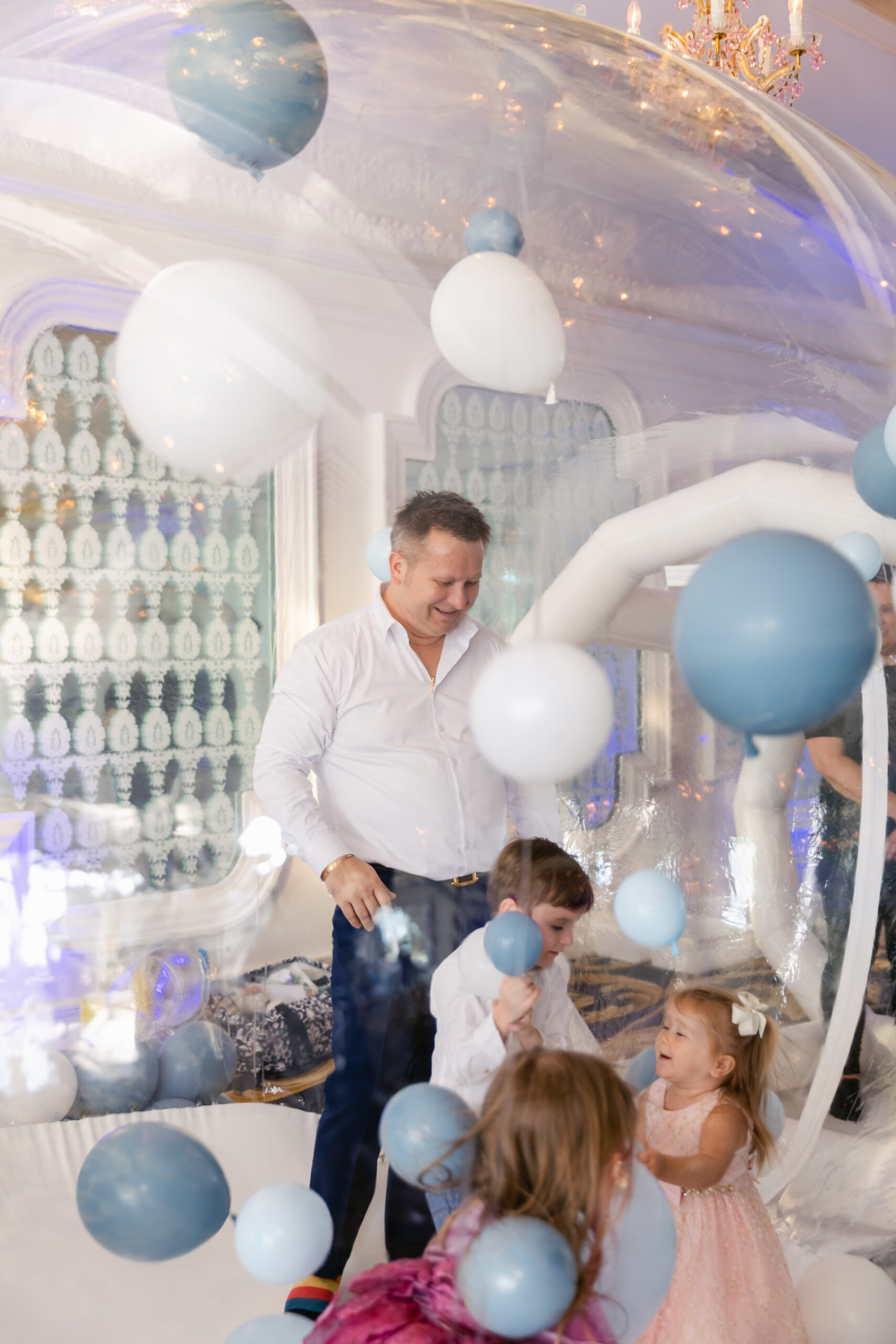 Kids playing in a ballon house at baptism reception