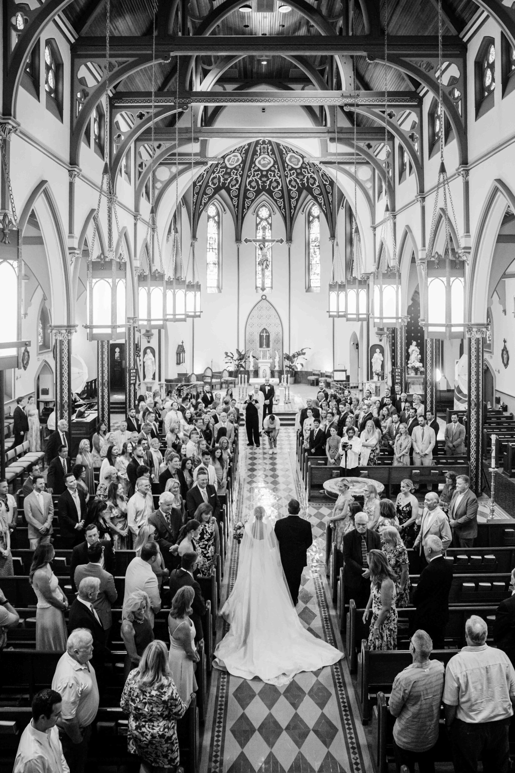 ariel photo of bride walking down the aisle in black and white