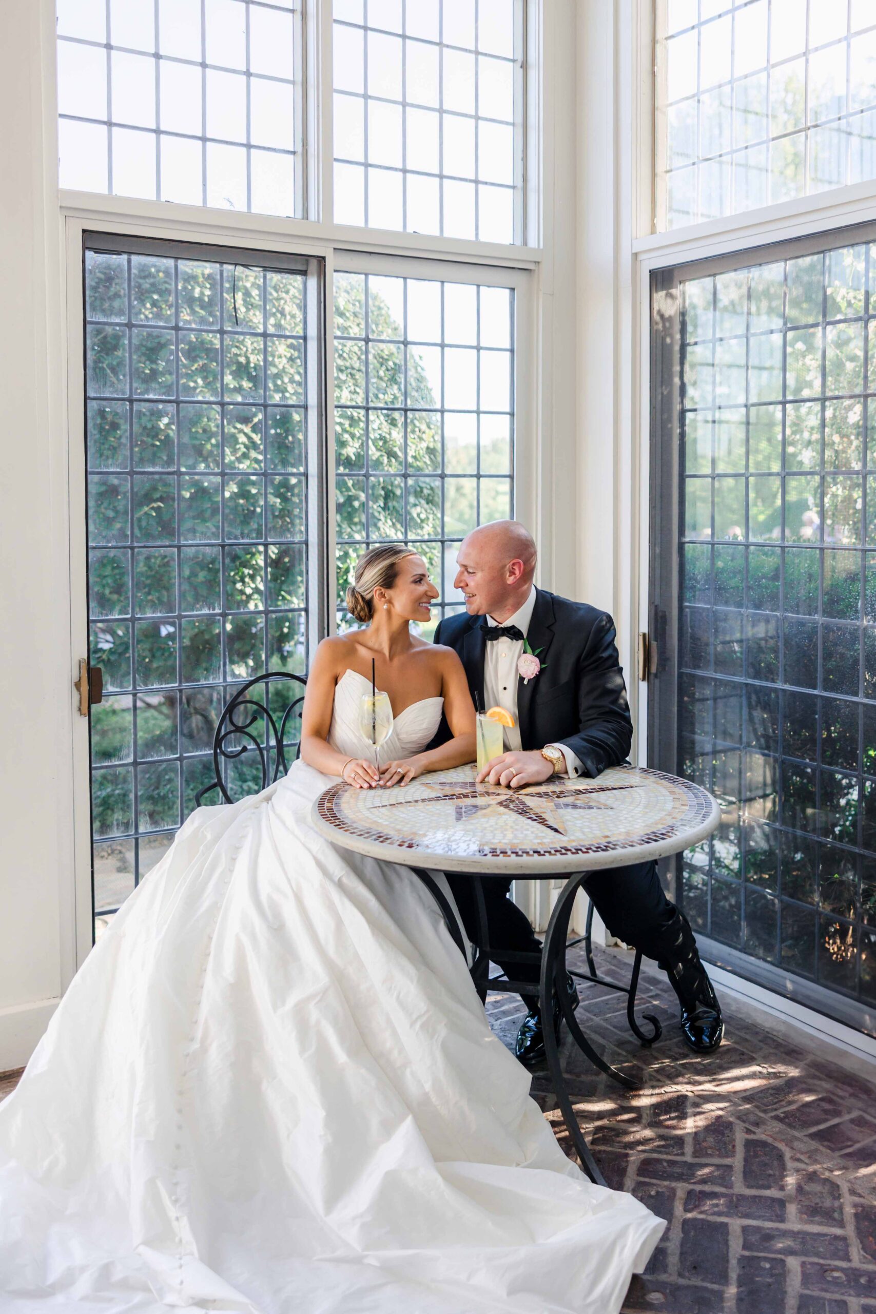 bride and groom sharing a drink on wedding day