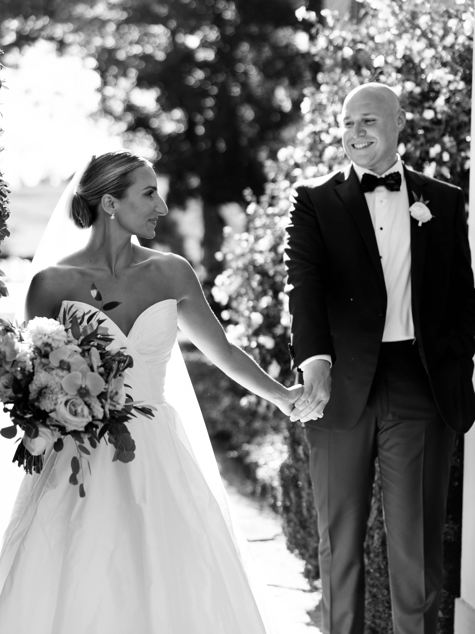 black and white photo bride and groom walking