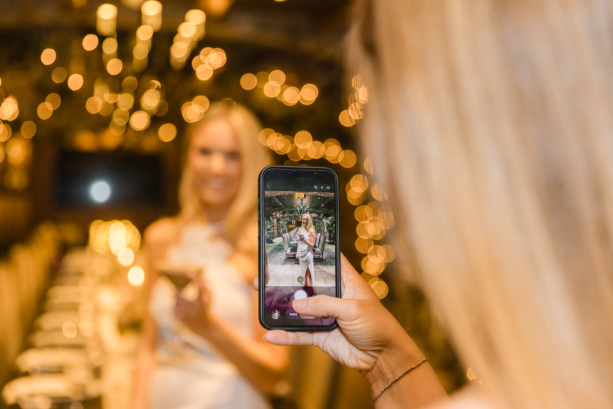 friends taking photos of bride